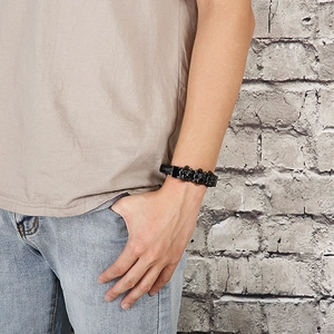 Punk style men's black braided leather bracelet with skull and obsidian charm beads