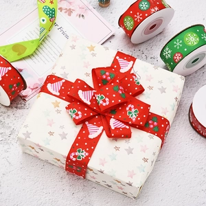 Close-up of red and green Christmas ribbons with festive patterns for gift box decoration
