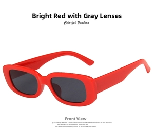 Detail view of retro red rectangular frame sunglasses with dark gray lenses