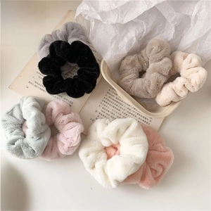 Set of 7 plush faux fur scrunchies in assorted colors for cozy winter hairstyles