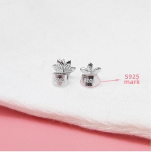 Macro shot of S925 sterling silver stamp on minimalist leaf-shaped earring studs