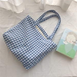 Detailed close-up of blue and white gingham cotton tote bag with soft fabric lining