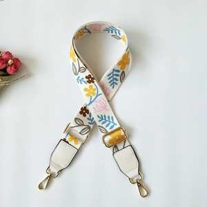 Tracolla regolabile in tela a fiori con estremità in pelle beige e fibbie dorate