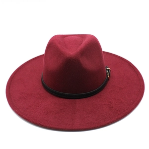 Detail of burgundy wool fedora hat featuring black leather band and gold metal buckle