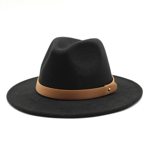 Detail of black wool fedora with brown leather band and gold metallic stud accent