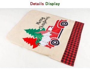 Detail display of linen Christmas chair cover with red truck and gnome embroidery print