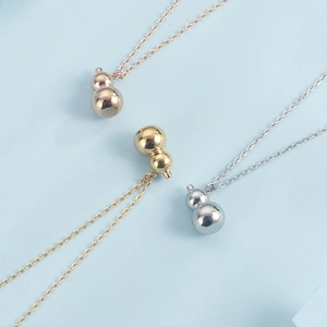 Gourd pendant necklaces in gold, silver and rose gold finishes on blue background