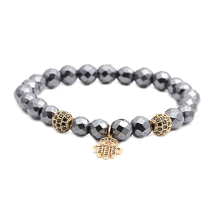 Faceted hematite beaded bracelet with golden Hamsa Hand charm and sparkling micro-pave stones