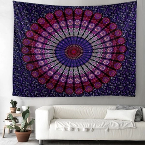 Detail of bohemian mandala tapestry hanging above a white sofa in a modern living room decor