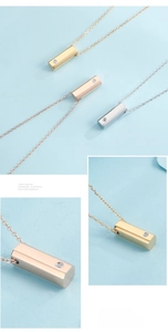 Close-up of three hexagonal pendant necklaces with embedded zircon in gold and silver