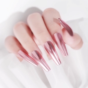 Close-up of chrome rose gold coffin nails with mirror finish on white silk background