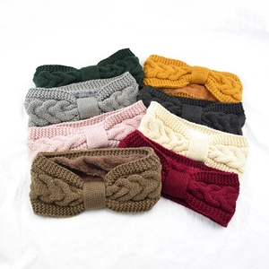 Close-up of assorted cable-knit headbands with warm fleece lining in eight vibrant colors