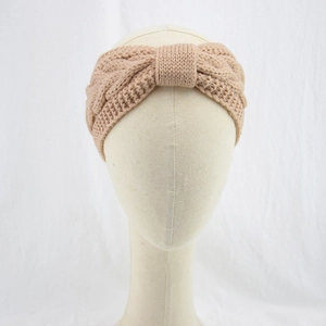 Detail view of the cable knit texture and bow knot design on the beige winter headband