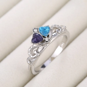 S925 silver crown ring featuring blue and purple heart-shaped zircons on beige velvet
