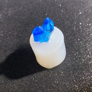 Detailed view of DIY resin crystal cluster mold with blue translucent gemstone top