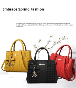 Detail of woven texture leather tote bags with metal heart charms in yellow, black and red