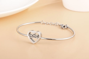 Close-up of silver minimalist mama heart bracelet with adjustable chain and lobster clasp