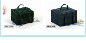 Macro shot of dark green and navy blue velvet travel jewelry boxes with soft handles