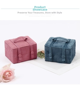 Pink and blue velvet jewelry boxes with portable handles and strap buckle detail