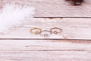 Three minimalist thin rings in gold silver and rose gold finishes with round zircons