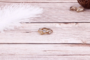 Close-up of three-piece minimalist slim ring set in silver gold and rose gold finishes