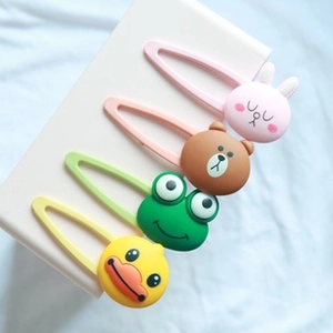 Close-up of cute cartoon animal hair clips featuring pink rabbit and brown bear designs