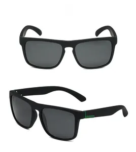 Detail of polarized sports sunglasses with matte black frames and green accents