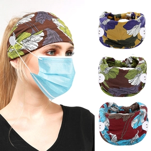 Detail of printed yoga headband with side buttons for mask ear relief and floral patterns