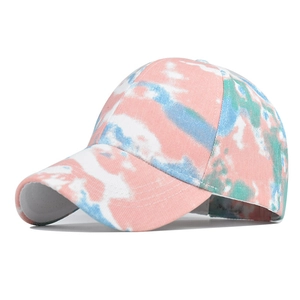 Detail of pink and blue tie-dye cotton baseball cap with textured fabric and stitching