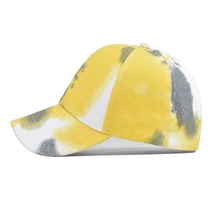 Detail view of cotton tie-dye baseball cap featuring yellow, white and gray patterns