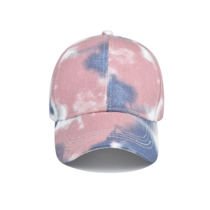 Close-up of pink and blue tie-dye cotton baseball cap with curved brim and stitching
