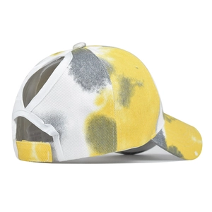 Detail view of tie-dye ponytail baseball cap with elastic criss-cross back straps
