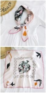 Detailed views of pink silk scarf featuring elegant bird and geometric floral patterns
