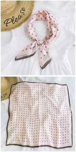 Detail of pink satin square scarf with geometric triangles and contrast edge