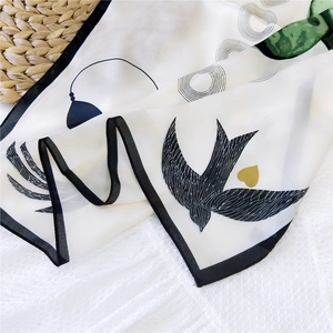 Elegant silk scarf with black swallow and yellow heart prints on beige fabric base