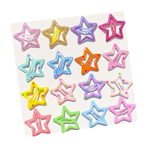 Set of colorful star-shaped metal hair clips with glitter and polka dots on display card