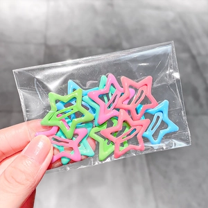 Set of 10 colorful star shaped metal hair clips in transparent packaging for kids