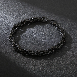 Detail of black stainless steel woven chain bracelet with secure lobster clasp closure
