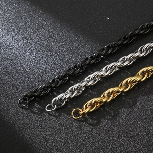 Detail shot of men's stainless steel double chain bracelets in gold, silver, and black finishes