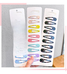 Detailed view of colorful polka dot metal snap hair clips organized on display cards
