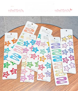 Macro detail of colorful candy-colored star and teardrop hair clips on display card