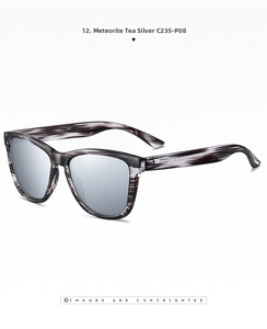 Close-up of polarized sunglasses with grey-black striped frames and silver mirror lenses