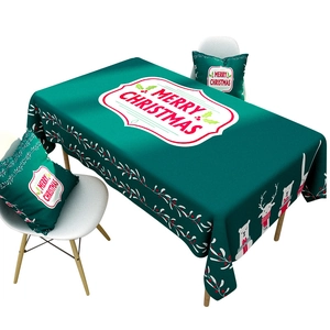 Green Christmas tablecloth and pillows with reindeer and polar bear patterns