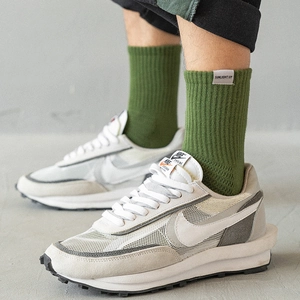 Forest green cotton crew socks with Sunlight Up label paired with stylish sneakers