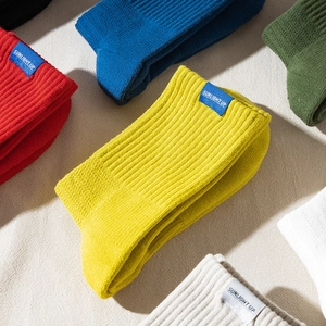 Multi-colored breathable mid-calf crew socks with towel bottom and woven letter tags