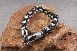 Macro view of woven black leather and 316L stainless steel hook buckle on men's bracelet