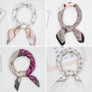 Detail showing four assorted 70x70 square silk scarves with classic chain and geometric patterns