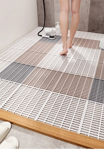 Detail of interlocking non-slip TPE bathroom floor tiles in white, grey and brown colors