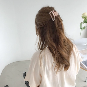 Pink square acrylic hair claw clip for women shown on model for a stylish hair styling