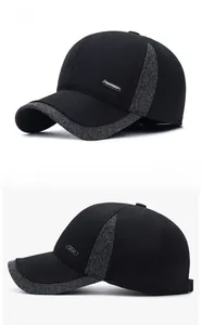 Detail of winter baseball cap with ear protection, sport metal badge, and grey fabric trim